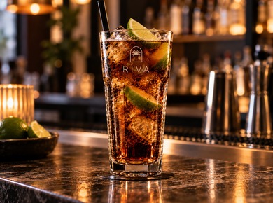 Cocktail in a tall highball glass featuring a bar logo