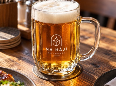 Beer glass featuring a restaurant logo during table service